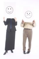 Choosing joy or unhappiness, illustrated with a smiley face and a frowny face