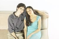 Guy and girl sitting together on a couch