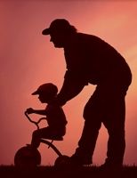 Dad and son on a tricycle silhouette nostalgic photo
