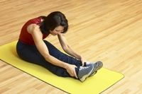 Exercise photo of a woman stretching on a mat