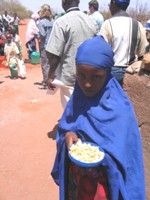 Young girl receiving food aid, courtesy USAID-Nancy Estes, 2006