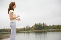 Girl standing by a lake thinking photo