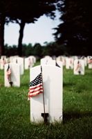 Grave stones and American flags illustrating Memorial Day