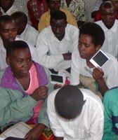 Watching Polaroid photos develop in Giti, Rwanda (photo courtesy Karen Meeker).
