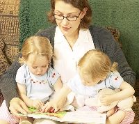 Mom reading to two young children