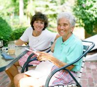 Photo of a younger and a older woman smiling