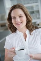 Smiling woman with coffee photo