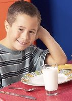 Photo of a boy with a glass of milk