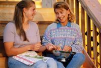 Conversation between two women while snapping beans