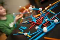 Young person playing with an educational chemistry model