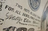 Fake $100 bill painted on a wall; real counterfeits look much more real. Photo to illustrate concept of counterfeit religions.