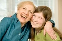 Photo of a grandmother hugging her granddaughter