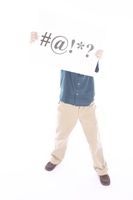 Man holding up sign with #@!*? on it